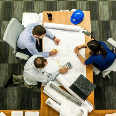 Three People Sitting Beside Table